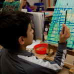 A child painting in an art class